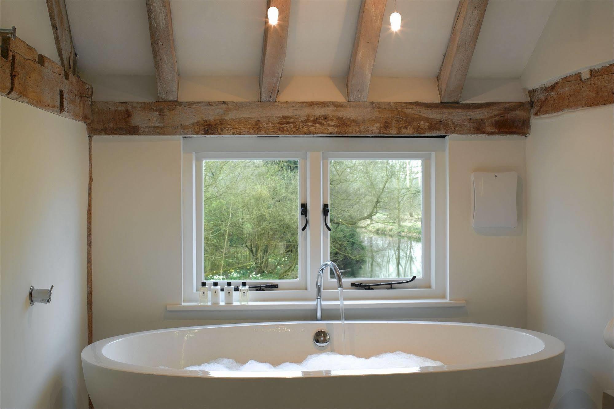 Tuddenham Mill Luxury Hotel Exterior photo A freestanding bathtub